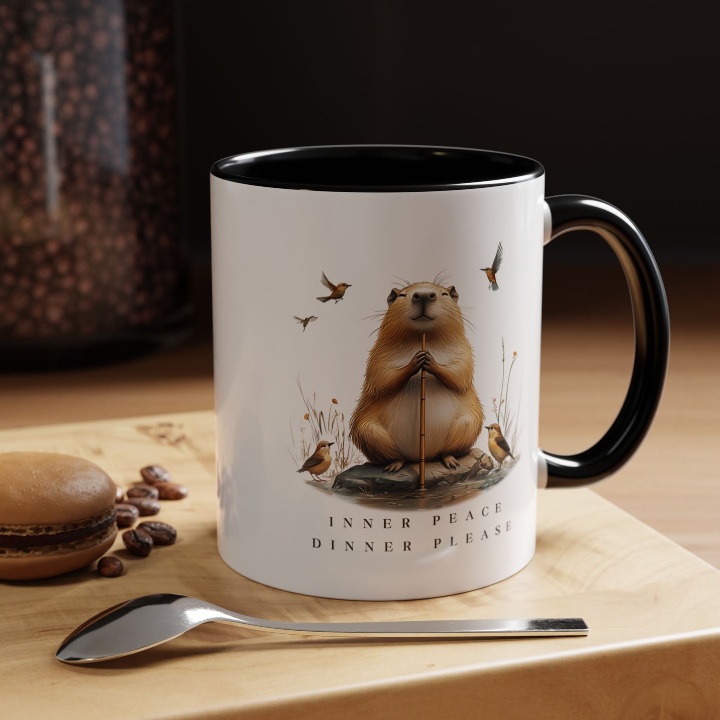 Black Inner Peace Capybara Mug. Featuring a serene capybara and the words "Inner Peace," this mug is perfect for moments of mindfulness and relaxation. Sip your favorite beverage and embrace tranquility with every sip.