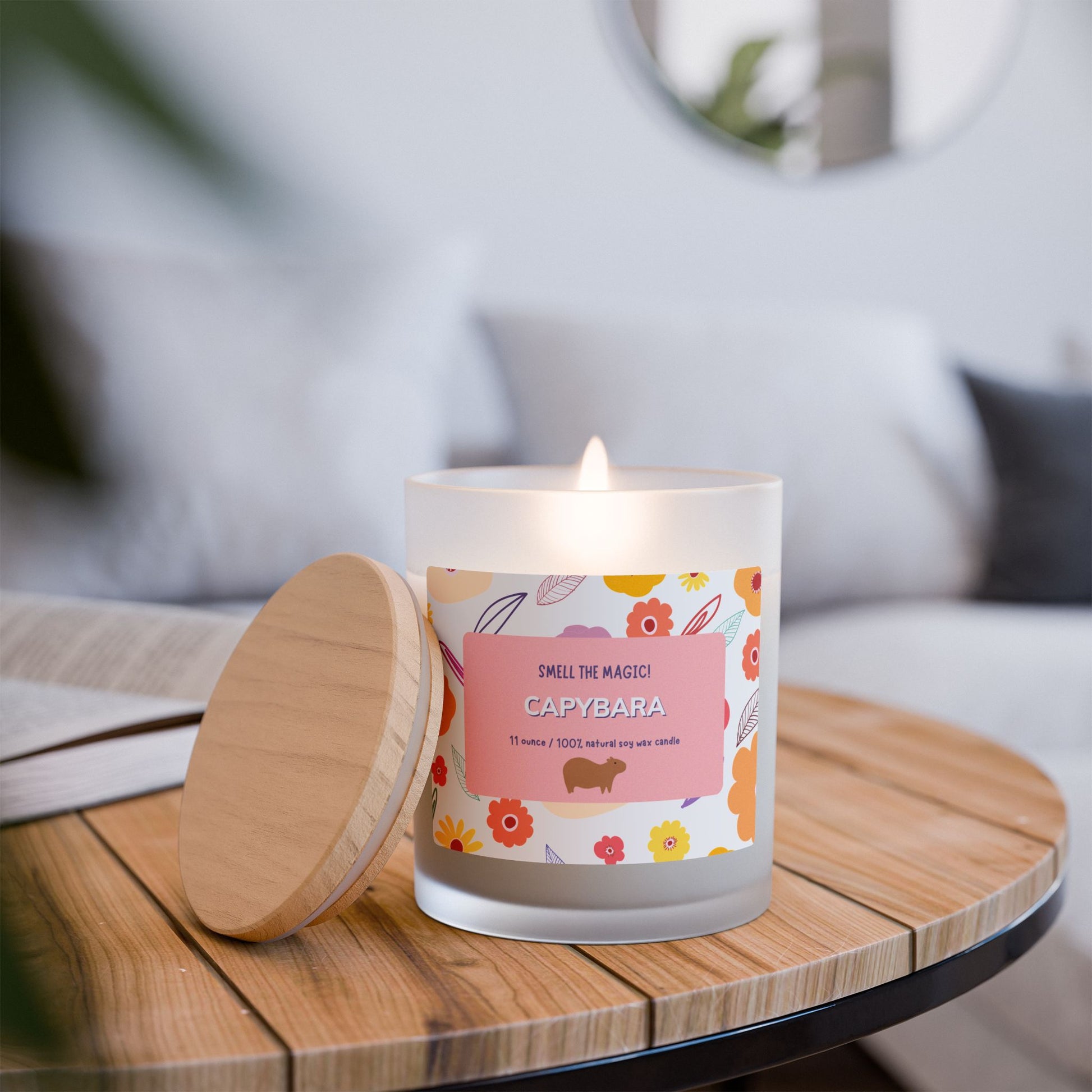 Capybara Gift 11oz Frost Candle, featuring a funny label featuring a cute capybara and a flowery background. It has an unique wooden wick that crackles gently as it burns. This exquisite candle is more than just a light source—it's an elegant piece of decor