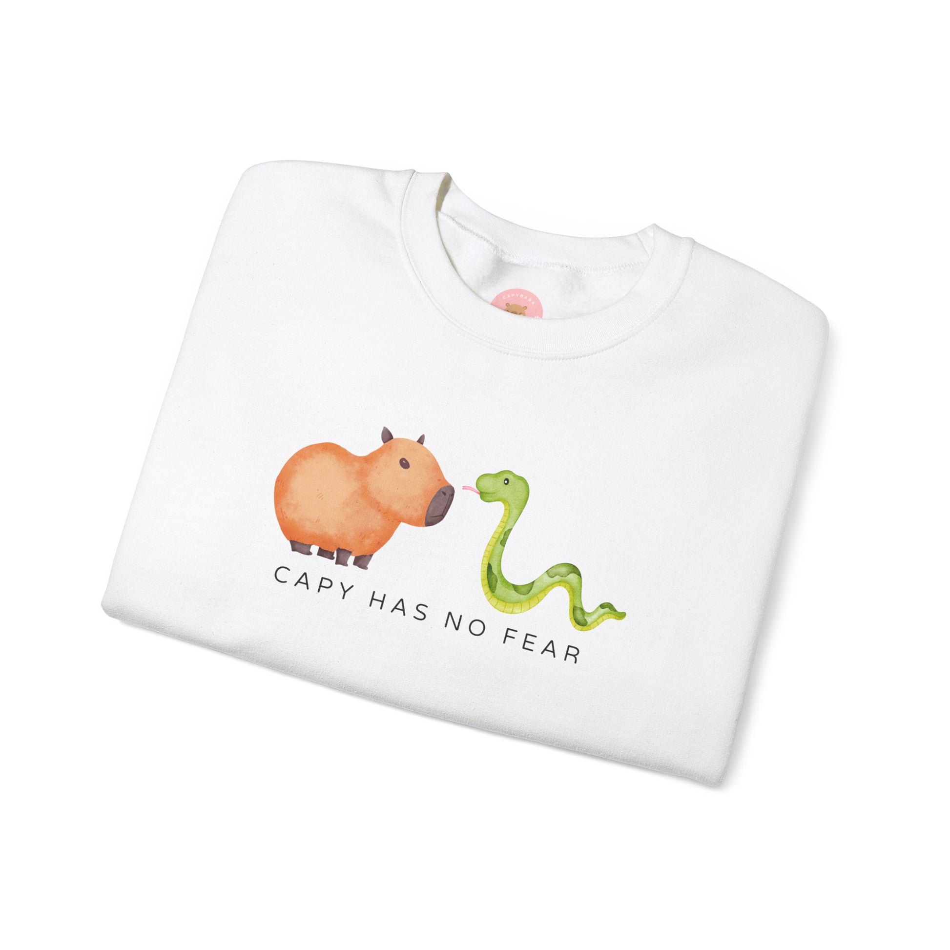 CNY Capybara clothes, Year of the Snake in style with our 'Capy has no fear' Crewneck Sweatshirt! Featuring a bold graphic of a fearless capybara facing a snake, this design is a humorous and symbolic nod to the Chinese New Year. Show off your courage and charm while staying cozy—perfect for family gatherings and festive celebrations!