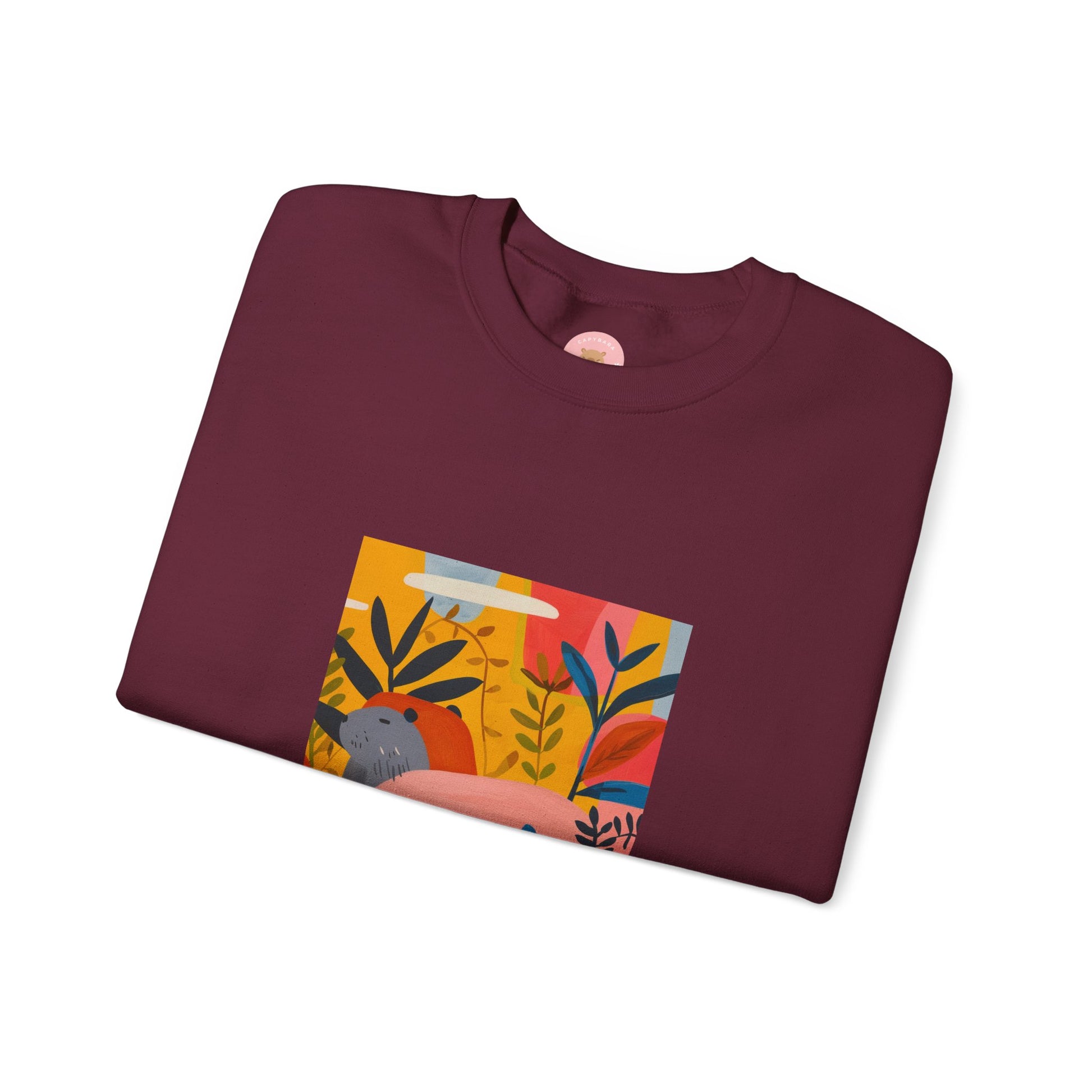 Maroon Capybara sweatshirt features a painting inspired by Henri Matisse with a funny twist, perfect for capybara lovers and art enthusiasts. It offers a cozy and comfortable fit, making it ideal for colder months. The medium-heavy fabric blend of cotton and polyester ensures durability and warmth. Great for snuggling up at home or showcasing your unique style.
