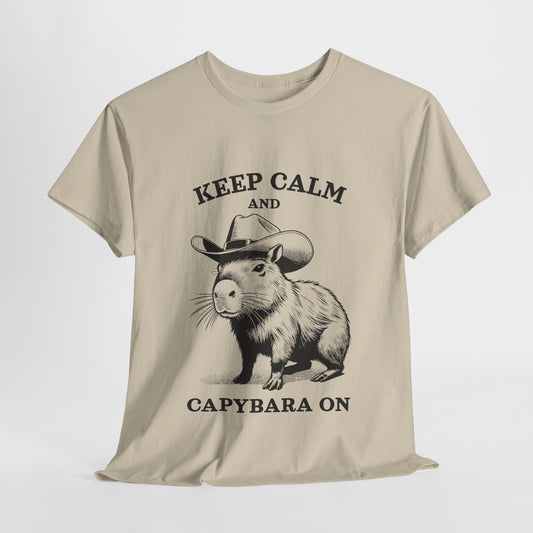 Vintage-style graphic T-shirt featuring a cowboy capybara with the phrase “Keep Calm and Capybara On.” This funny animal shirt blends Western charm with chill vibes, making it perfect for capybara lovers, cowboy fans, or anyone who appreciates quirky humor. Great gift idea for birthdays, holidays, or casual wear with a relaxed fit and rustic design. Unisex style for men and women who love cool animal tees with a laid-back attitude.