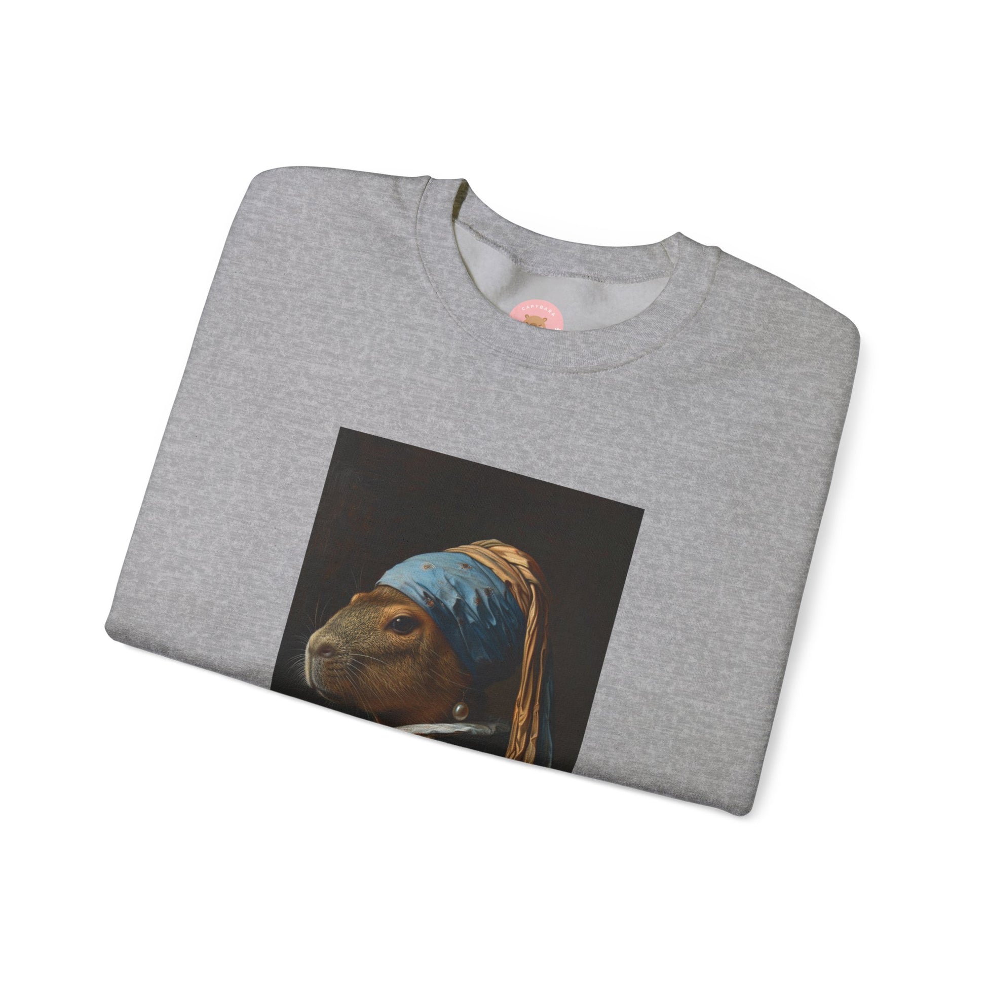 Capy de Vermeer Capybara sweatshirt features a painting inspired by VERMEER's famous painting - A Girl With A Pearl Earring. It's a fun twist for capybara lovers and art enthusiasts, giving off a whimsical and artistic vibe. Perfect for those who appreciate unique and creative designs, this sweatshirt is relevant for art lovers, animal enthusiasts, and those looking for a quirky addition to their wardrobe. Ideal for gifting during birthdays, Christmas, or any special occasion.