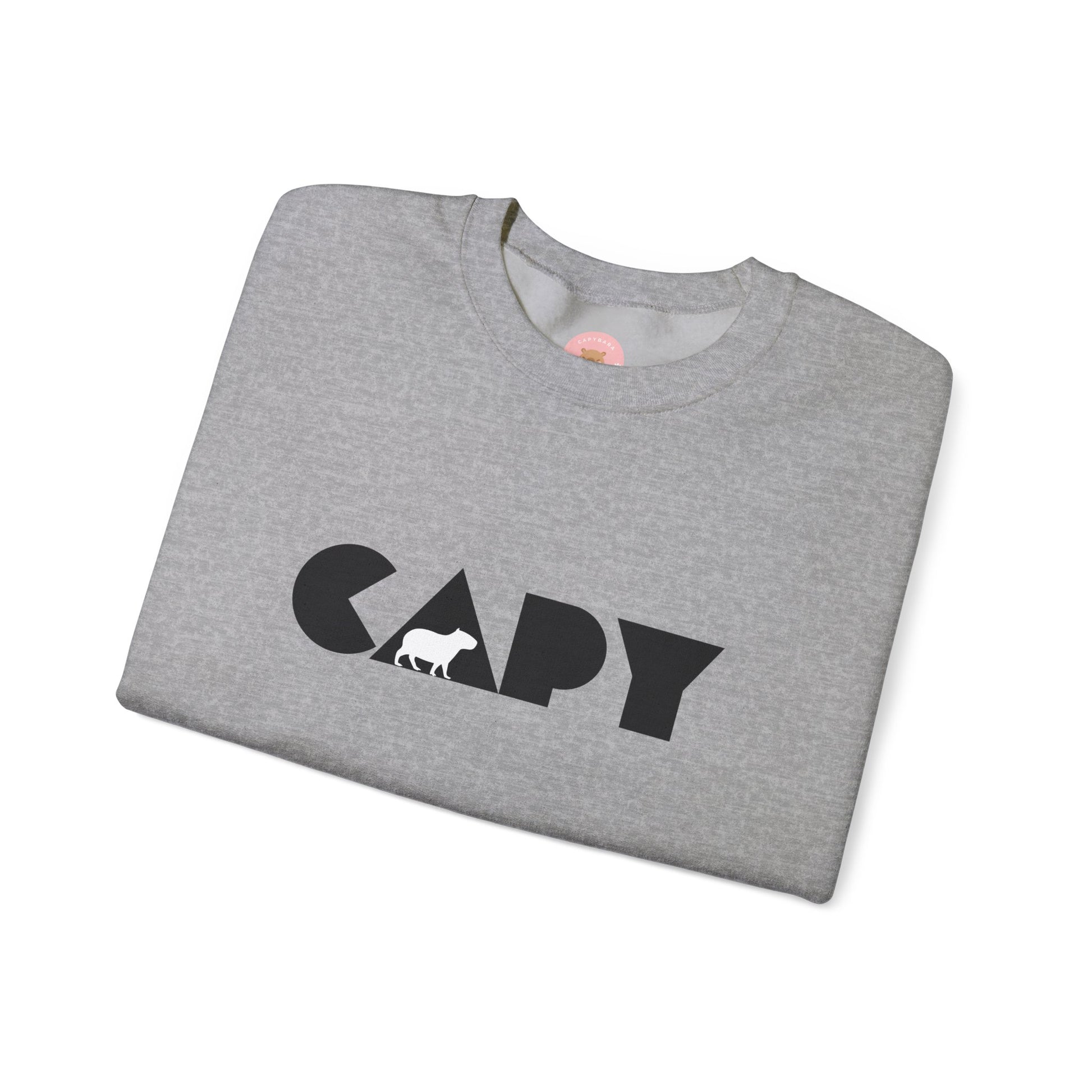Capybara sweatshirt features the stylish plain text design of the word CAPY with a capybara graphic embedded. It offers a comfy wearing experience with a classic fit and crew neckline. Perfect for colder months, this sweatshirt is ideal for those who love unique and chill designs. The target audience includes individuals who enjoy cozy apparel with a touch of personality. Relevant for holidays, casual gatherings, and everyday wear.