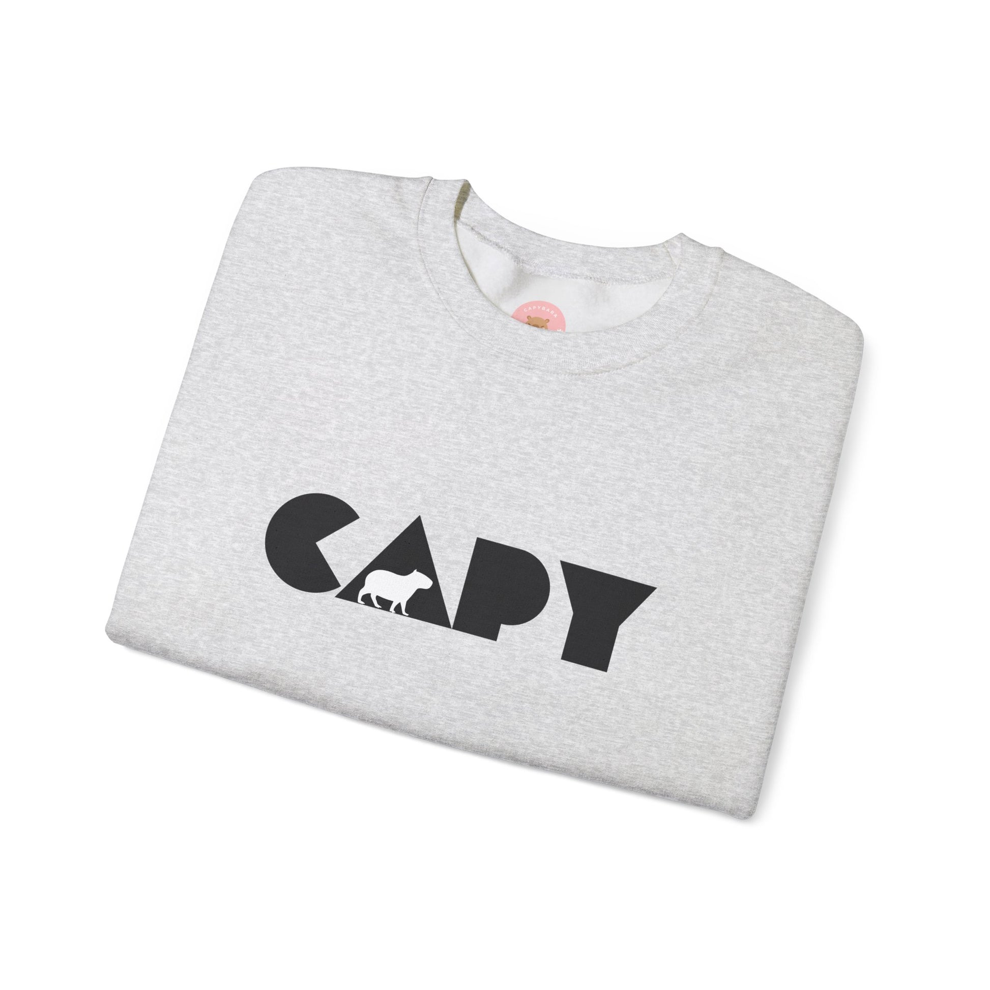Capybara sweatshirt features the stylish plain text design of the word CAPY with a capybara graphic embedded. It offers a comfy wearing experience with a classic fit and crew neckline. Perfect for colder months, this sweatshirt is ideal for those who love unique and chill designs. The target audience includes individuals who enjoy cozy apparel with a touch of personality. Relevant for holidays, casual gatherings, and everyday wear.