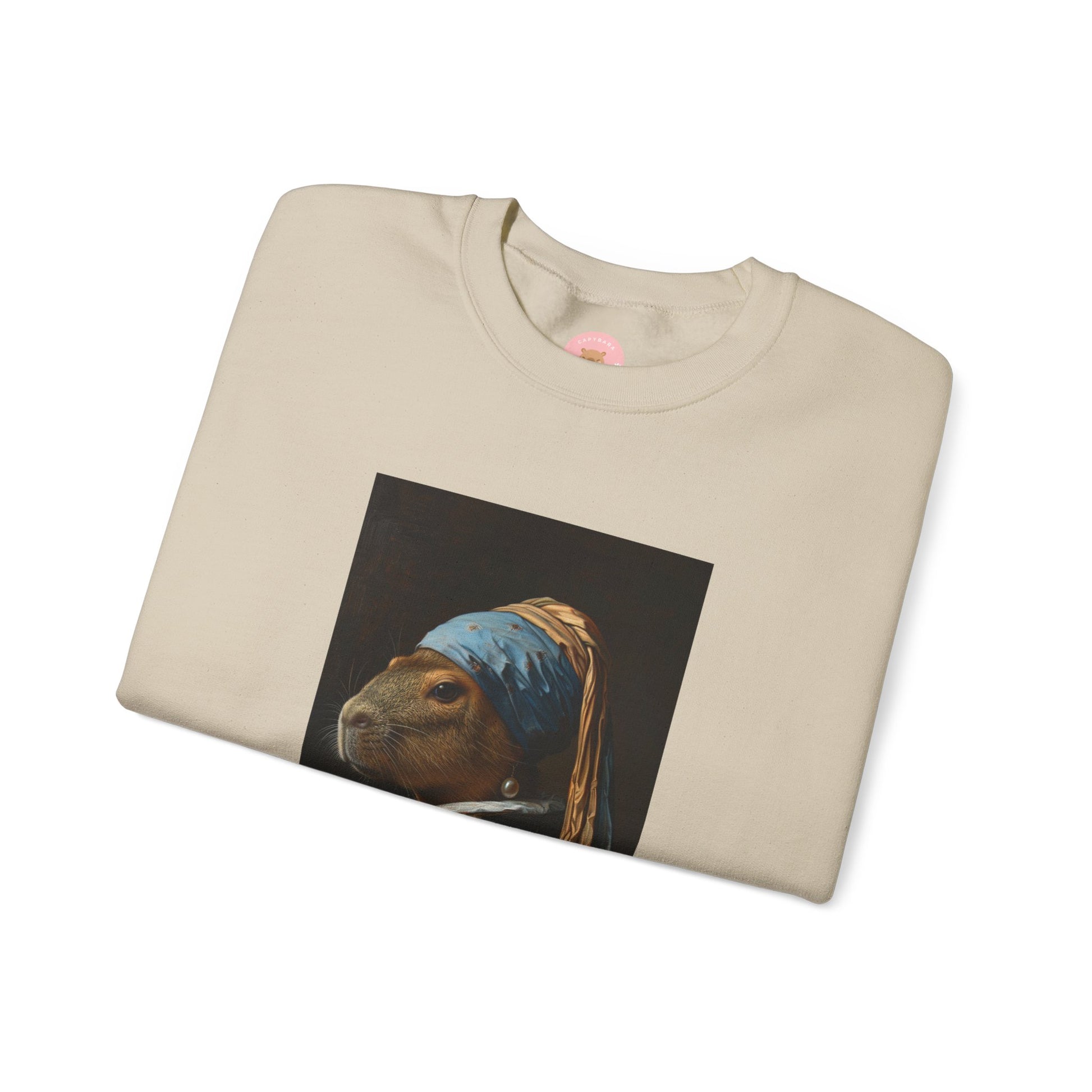 Capy de Vermeer Capybara sweatshirt features a painting inspired by VERMEER's famous painting - A Girl With A Pearl Earring. It's a fun twist for capybara lovers and art enthusiasts, giving off a whimsical and artistic vibe. Perfect for those who appreciate unique and creative designs, this sweatshirt is relevant for art lovers, animal enthusiasts, and those looking for a quirky addition to their wardrobe. Ideal for gifting during birthdays, Christmas, or any special occasion.