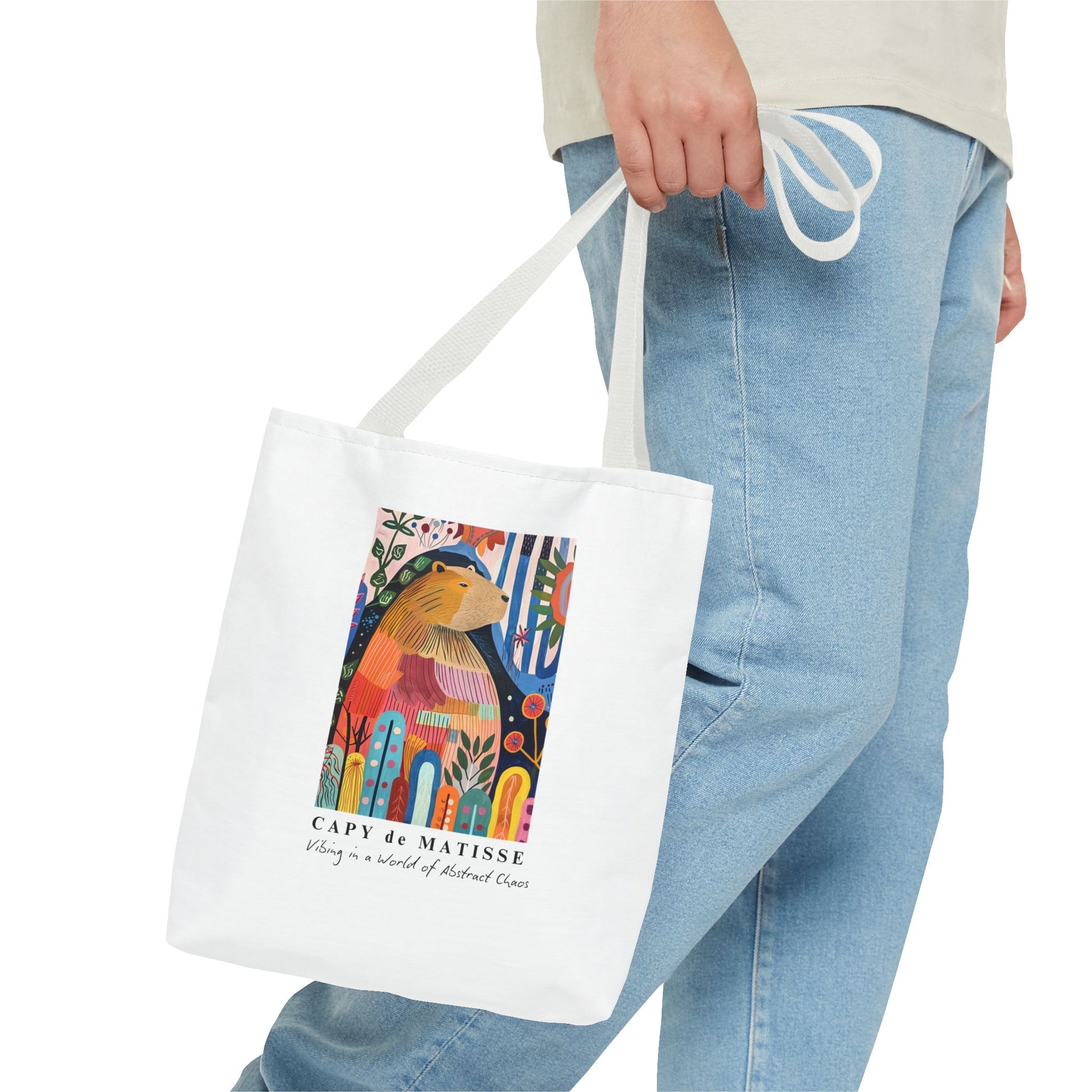 Capybara 13"x13" tote bag featuring a graphic of a painting inspired by artist Henri Matisse, with a hidden capybara. Perfect for art lovers and capybara enthusiasts, this tote bag adds a touch of artistic flair to your everyday errands. Great for carrying books, groceries, or daily essentials. Ideal for art enthusiasts, animal lovers, and those looking to add a pop of creativity to their style. Perfect for gifting on birthdays, holidays, or as a treat for yourself.