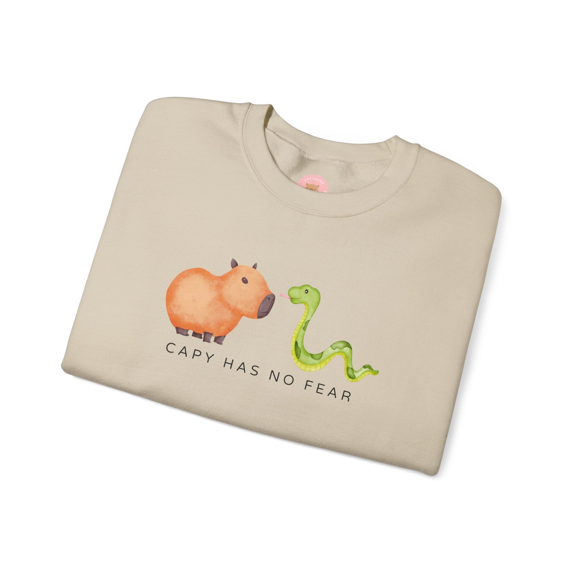 CNY Capybara clothes, Year of the Snake in style with our 'Capy has no fear' Crewneck Sweatshirt! Featuring a bold graphic of a fearless capybara facing a snake, this design is a humorous and symbolic nod to the Chinese New Year. Show off your courage and charm while staying cozy—perfect for family gatherings and festive celebrations!