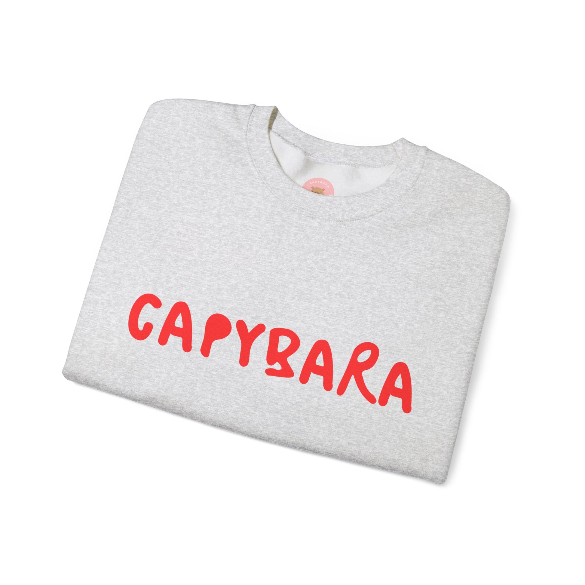 Capybara crewneck sweatshirt features the playful plain text design of CAPYBARA. It offers a comfy wearing experience with a classic fit and crew neckline. Perfect for colder months, this sweatshirt is ideal for those who love unique and chill designs. The target audience includes individuals who enjoy cozy apparel with a touch of personality. Relevant for holidays, casual gatherings, and everyday wear.