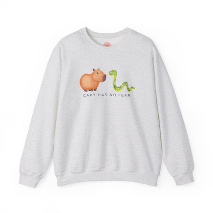 CNY Capybara clothes, Year of the Snake in style with our 'Capy has no fear' Crewneck Sweatshirt! Featuring a bold graphic of a fearless capybara facing a snake, this design is a humorous and symbolic nod to the Chinese New Year. Show off your courage and charm while staying cozy—perfect for family gatherings and festive celebrations!