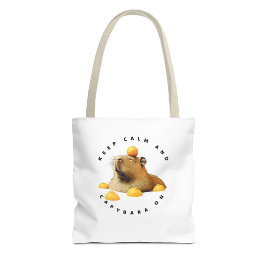Keep Calm and Capybara On tote bag. Eco-Friendly Tote Bag. Featuring a relaxing capybara enjoying a yuzu bath. It is great for everyday use, carrying groceries or as a fun gift. Made with 100% polyester, a medium-weight fabric that is highly durable.