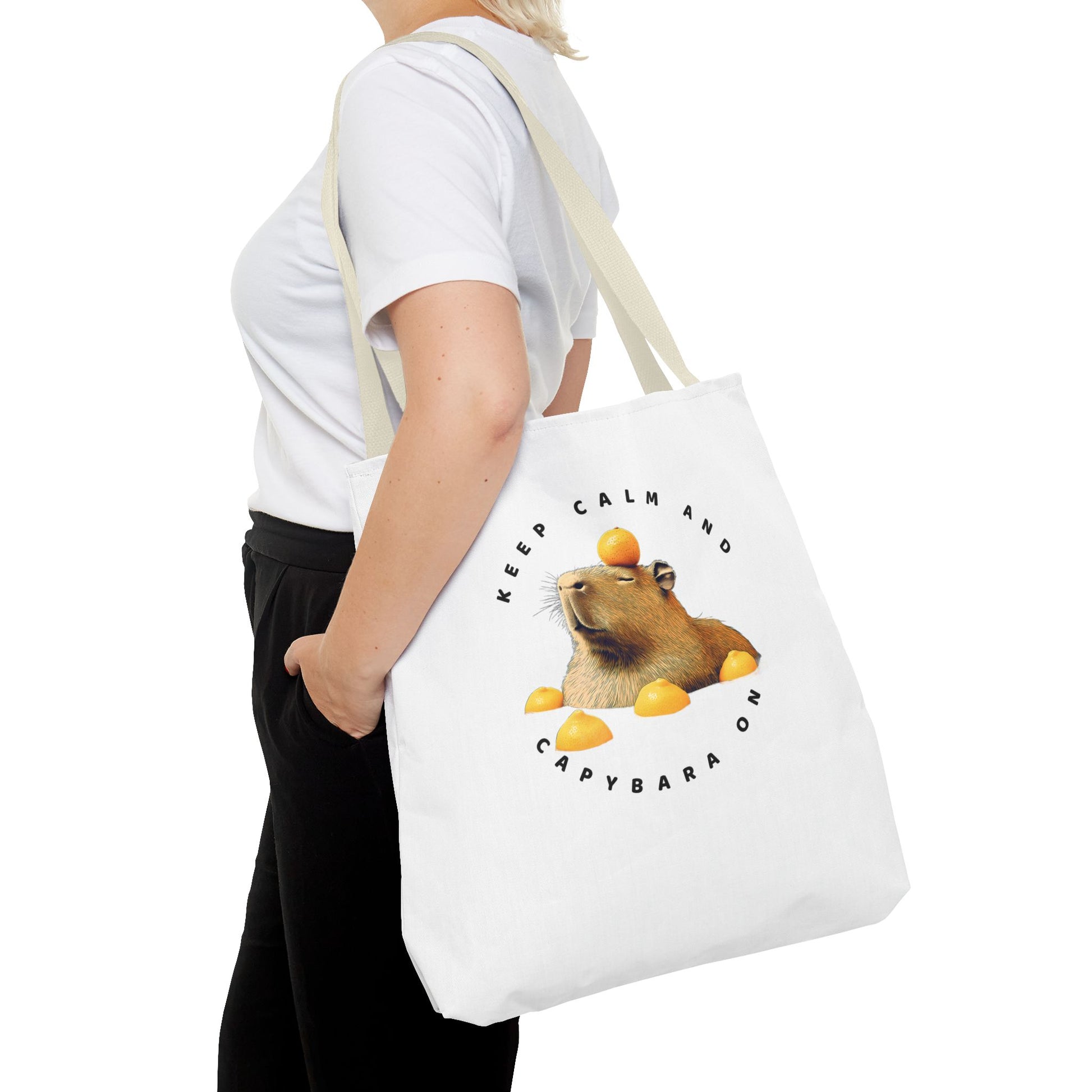 Keep Calm and Capybara On tote bag. Eco-Friendly Tote Bag. Featuring a relaxing capybara enjoying a yuzu bath. It is great for everyday use, carrying groceries or as a fun gift. Made with 100% polyester, a medium-weight fabric that is highly durable.