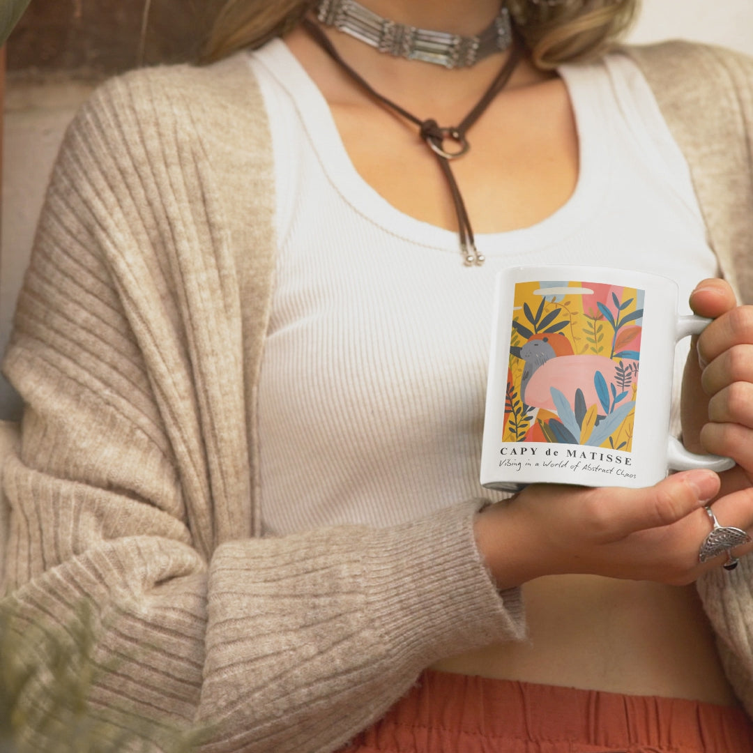 Capybara ceramic mug featuring a painting inspired by artist Henri Matisse, with a hidden capybara. Perfect for art lovers and capybara enthusiasts, creating a vibe of abstract chaos. Ideal for cozy mornings or artistic tea breaks. Relevant for art enthusiasts, animal lovers, and those who appreciate unique designs. Perfect for gifting on birthdays, Christmas, or as a thank you present.